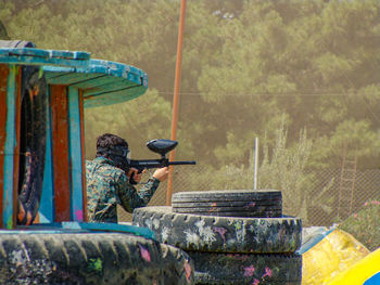 Shooting bullet from behind the trench in paintball 