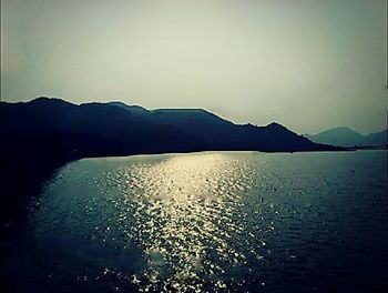 Scenic view of lake and mountains against sky