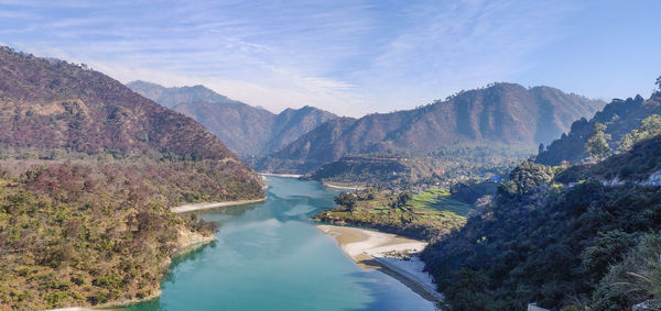 High angle view of lake amidst mountains against sky