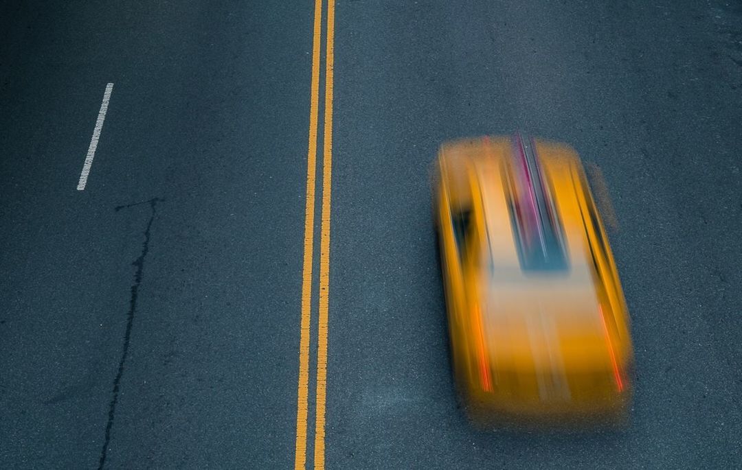 HIGH ANGLE VIEW OF YELLOW SIGN ON STREET