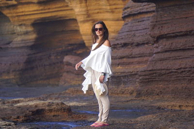 Portrait of woman wearing sunglasses at beach