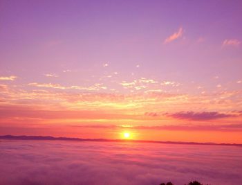 Scenic view of sea against romantic sky at sunset