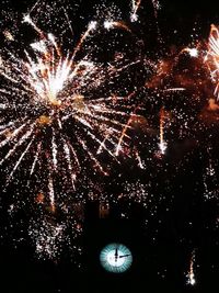 Low angle view of firework display at night