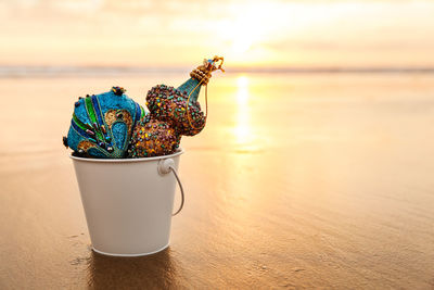 Close-up of water on table at beach during sunset