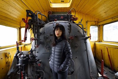 Portrait of woman standing in train