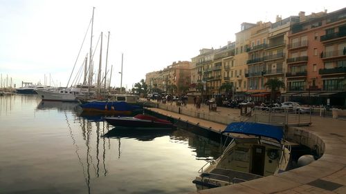 Boats moored on shore against sky