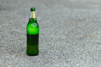 Close-up of green bottle on glass