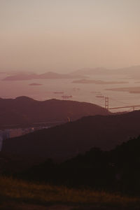 Scenic view of silhouette mountains against sky during sunset