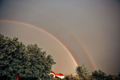 Low angle view of rainbow against sky at sunset