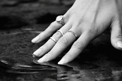 Cropped image of hand touching water