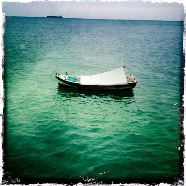 water, nautical vessel, boat, transportation, sea, mode of transport, transfer print, moored, tranquility, auto post production filter, horizon over water, tranquil scene, nature, rippled, beauty in nature, scenics, waterfront, blue, sailing, sky