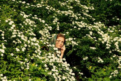 Portrait of woman in flower tree