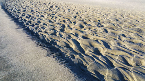 Tire tracks on sand at beach