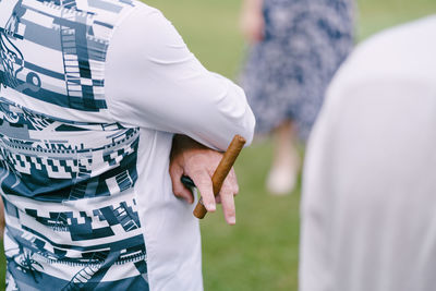 Midsection of couple holding hands standing outdoors