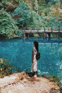 Woman standing against lake