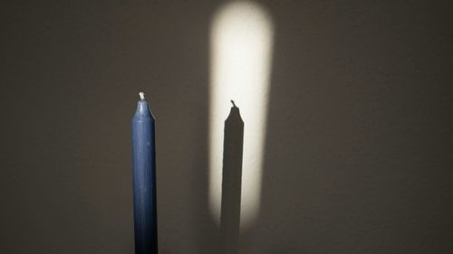 Close-up of candle against white background