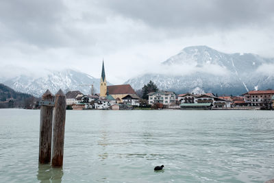 Scenic view of lake and snowcapped mountain against sky