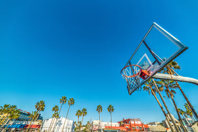 Low angle view of basketball hoop against clear blue sky