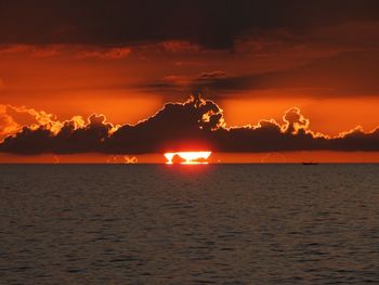 Scenic view of sea against romantic sky at sunset