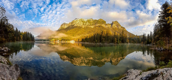 Panoramic view of lake and trees against sky