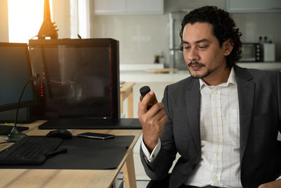 Mid adult man using mobile phone