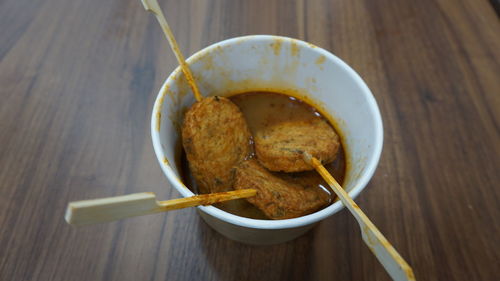 Three fish cake in curry on the table