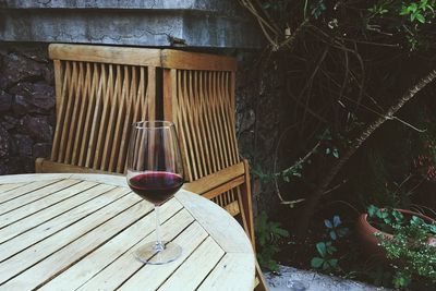 Close-up of wineglass on wooden table at yard