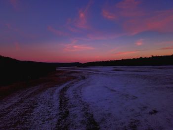 Scenic view of beach against sky during sunset