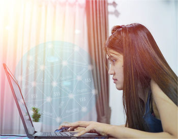 Digital composite image of woman using laptop 