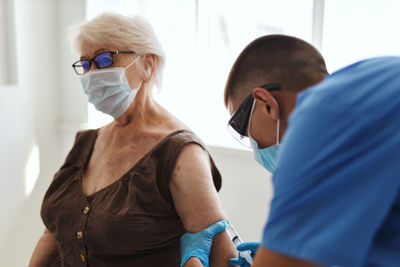 Doctor injecting vaccine to patient