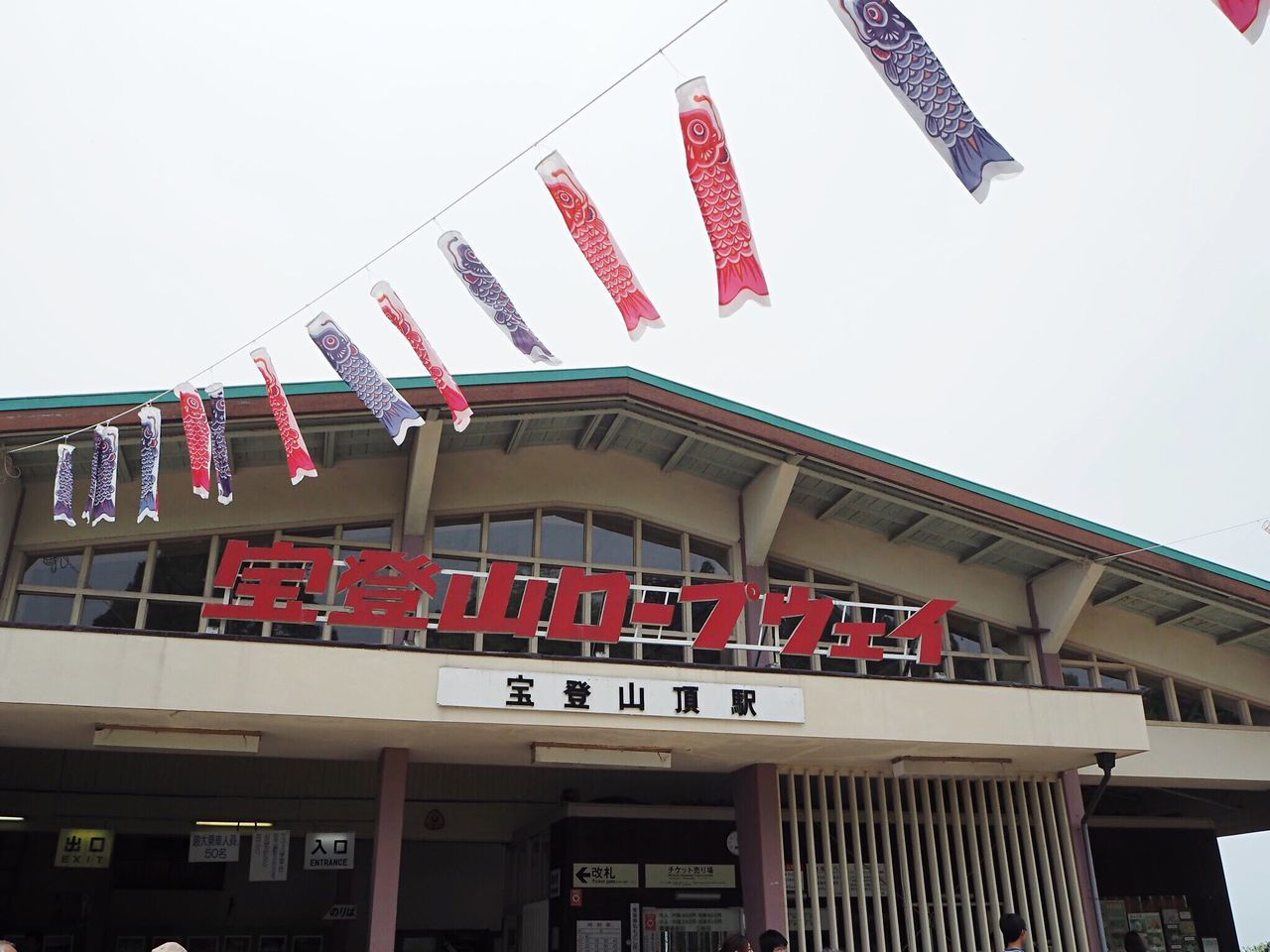 LOW ANGLE VIEW OF FLAGS HANGING AGAINST BUILDINGS