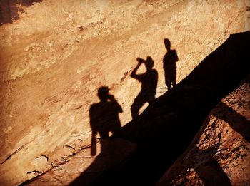 High angle view of silhouette people on rock