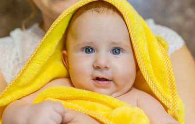 Portrait of smiling baby wearing towel at home