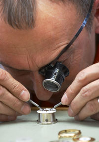 Close-up of watch maker at work