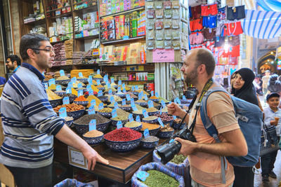 Friends standing at market stall