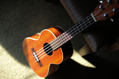 High angle view acoustic guitar in darkroom