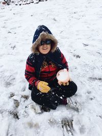 Young woman in snow covered field