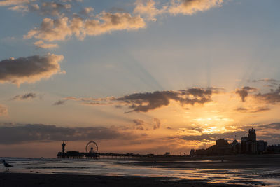 Scenic view of beach against sky during sunset