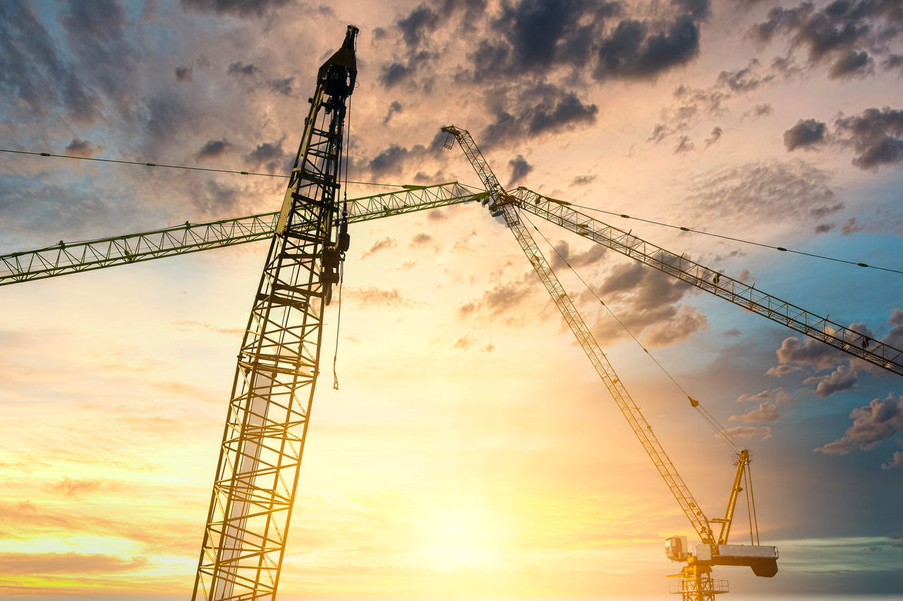 LOW ANGLE VIEW OF CRANE AT CONSTRUCTION SITE AGAINST SKY