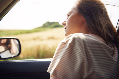 Midsection of woman in car