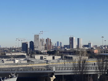 Modern buildings against clear blue sky