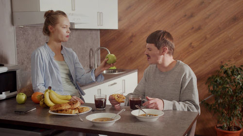 Wife and husband having discussion at kitchen