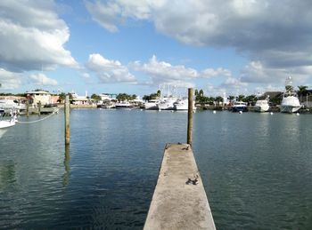 View of harbor against cloudy sky