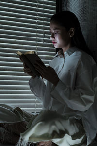 Side view of girl looking at camera