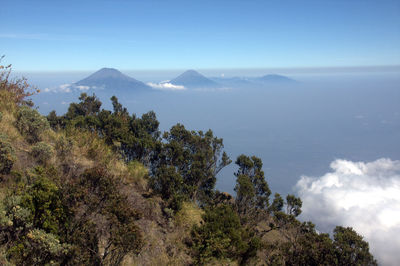 Scenic view of sea and mountains against sky