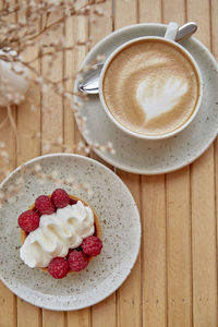 Aesthetic french tart and cup of cappuccino flat lay. atmospheric breakfast