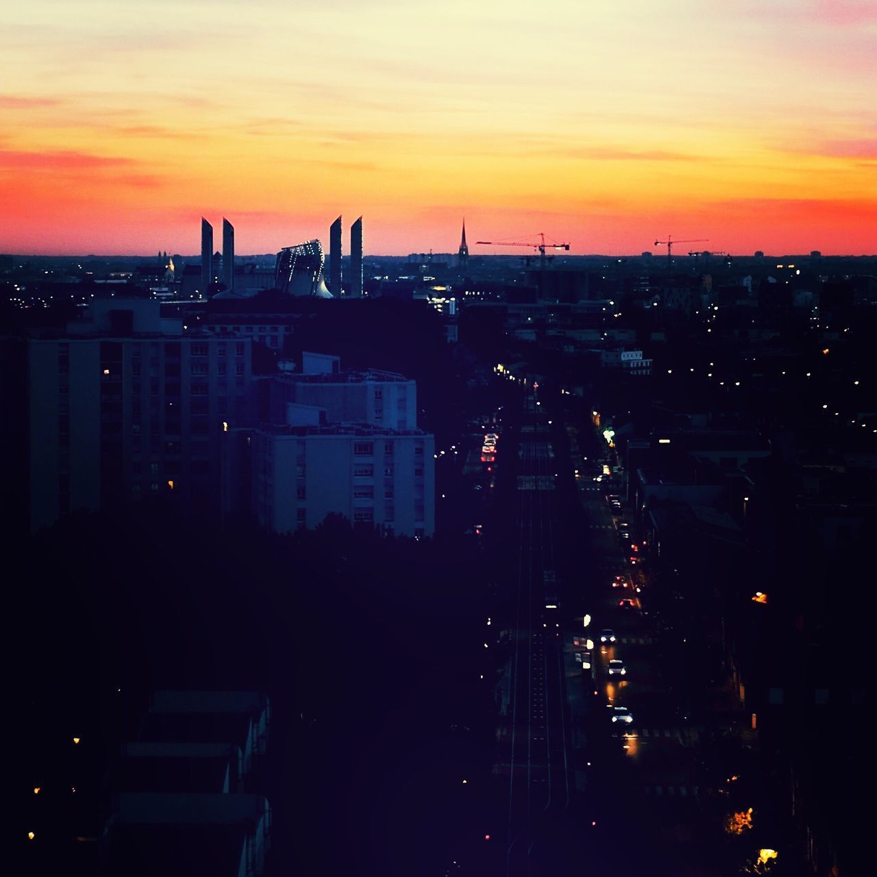 SILHOUETTE CITYSCAPE AGAINST SKY AT SUNSET