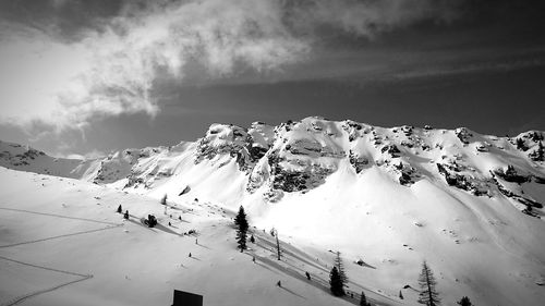 Scenic view of snow covered mountains against sky