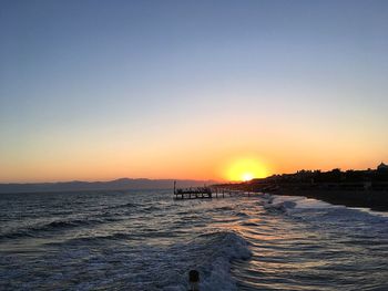 Scenic view of sea against clear sky during sunset