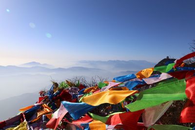 Prayer flags on mountain against sky